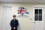 Hugh Rees-Beaumont standing next to a Lewisham Conservatives sign.
